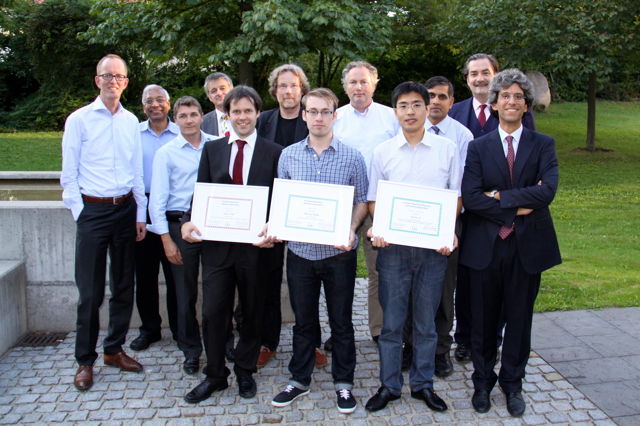 [Photo] Winners of the Awards 2013 together with the jury: Front (left to right): Tom Kevenaar, Jean-Christophe Fondeur, Peter Wild, Finnian Kelly, Huiibin Li, Patrizio Campisi &ndash; Back (left to right): Anil Jain, Christoph Busch, Raymond Veldhuis, G&uuml;nther Schumacher, Ajay Kumar, Alexander Nouak