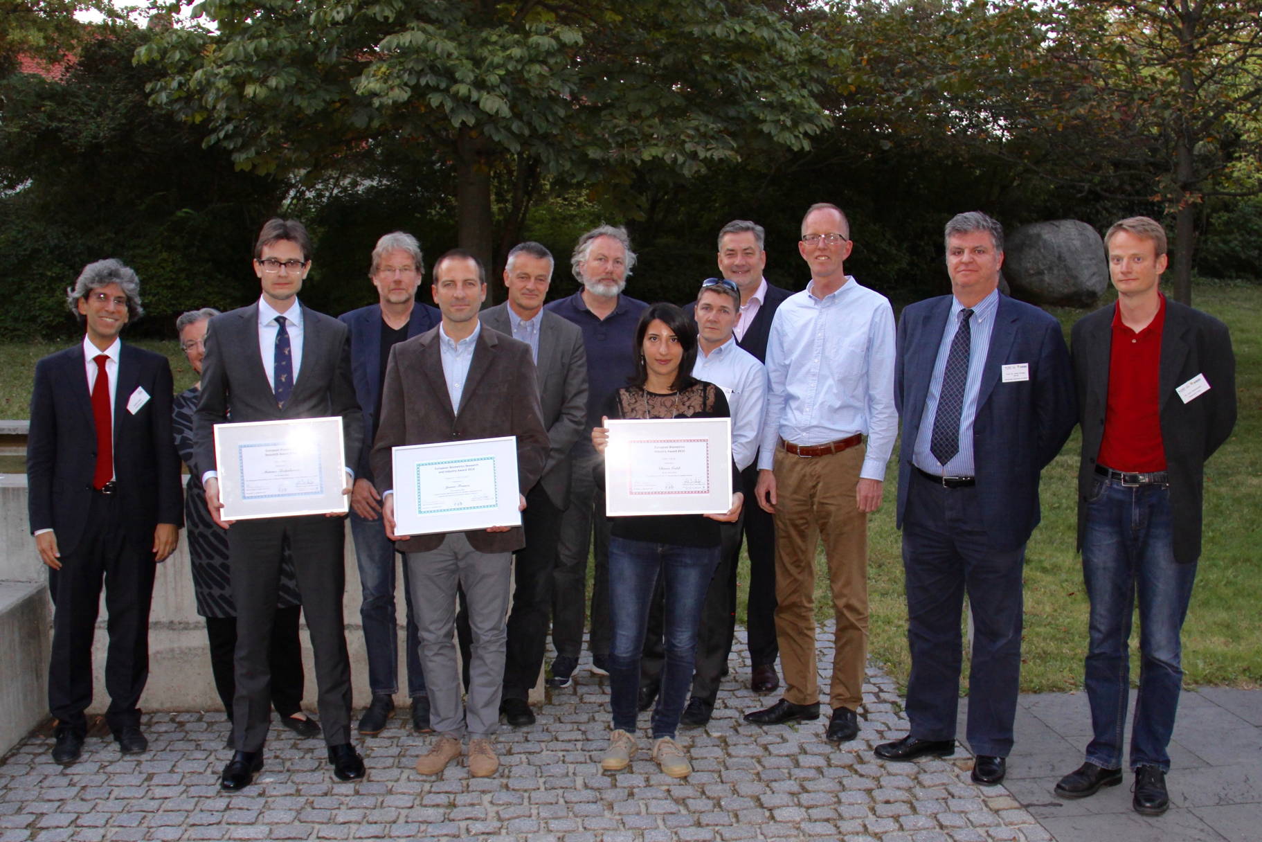 [Photo] Winners of the Awards 2016 together with the jury: (left to right): Patrizio Campisi, Dijana Petrovska Delacretaz, Mateusz Trokielewicz, Raymond Veldhuis, Javier Franco-Pedroso, Christoph Busch, G&uuml;nther Schumacher, Chiara Galdi, Jean-Christophe Fondeur, Alexander Nouak, Tom Kevenaar, Javier Ortega Garcia and Lars Christensen